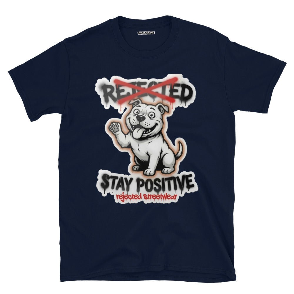 Stay Positive pit bull tee — white bully pup sitting with one paw raised, REJECTED crossed out in red