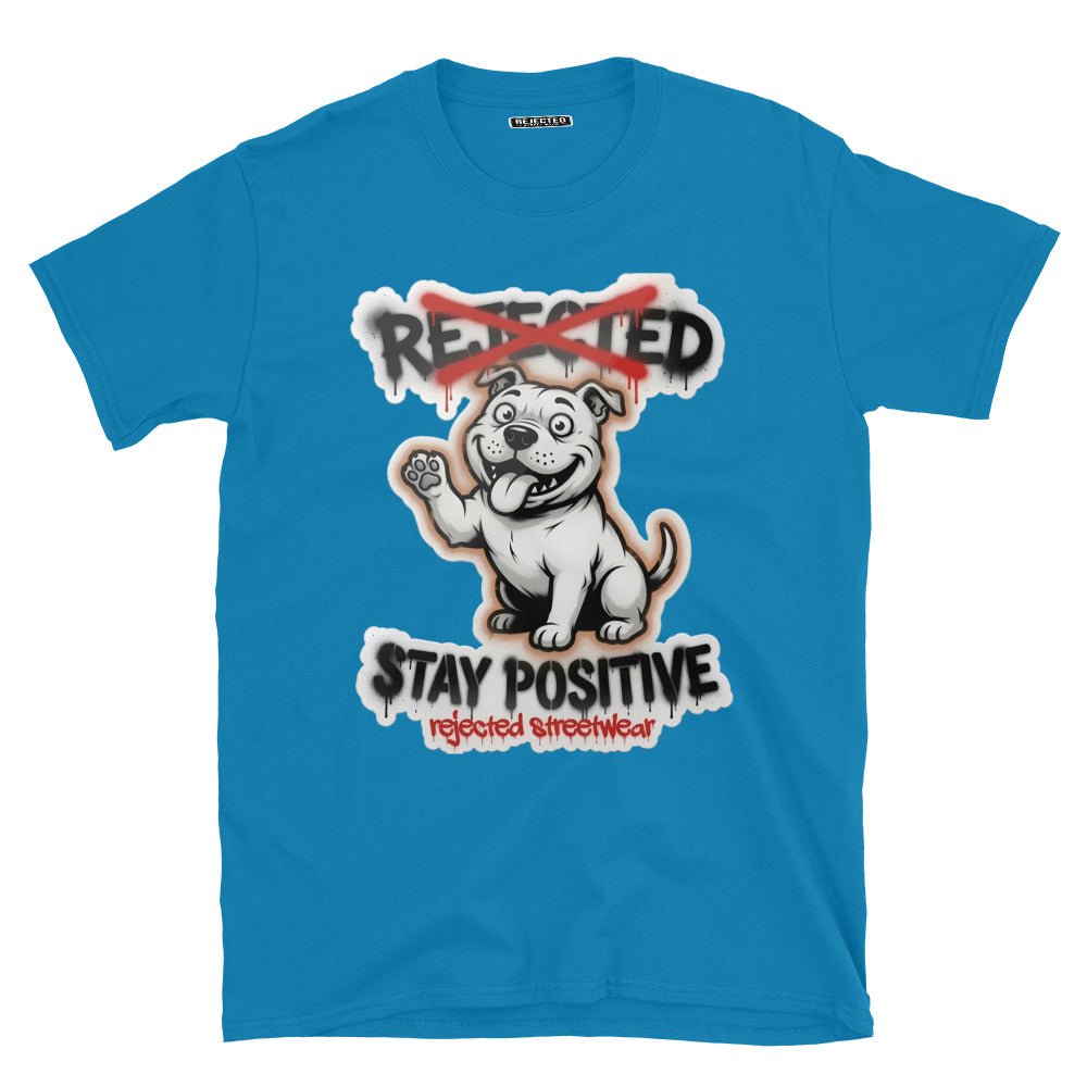 Stay Positive pit bull tee — white bully pup sitting with one paw raised, REJECTED crossed out in red