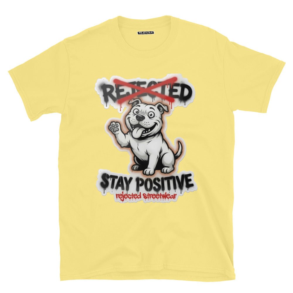 Stay Positive pit bull tee — white bully pup sitting with one paw raised, REJECTED crossed out in red