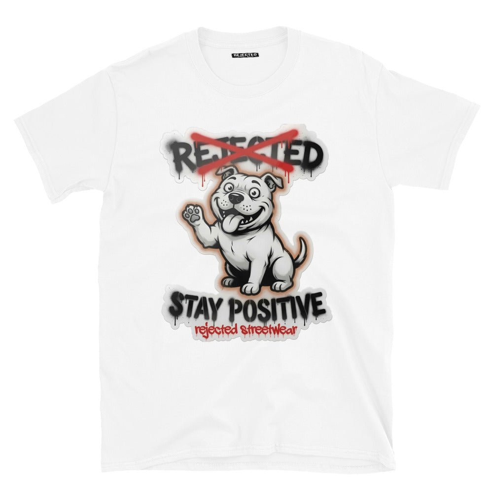 Stay Positive pit bull tee — white bully pup sitting with one paw raised, REJECTED crossed out in red