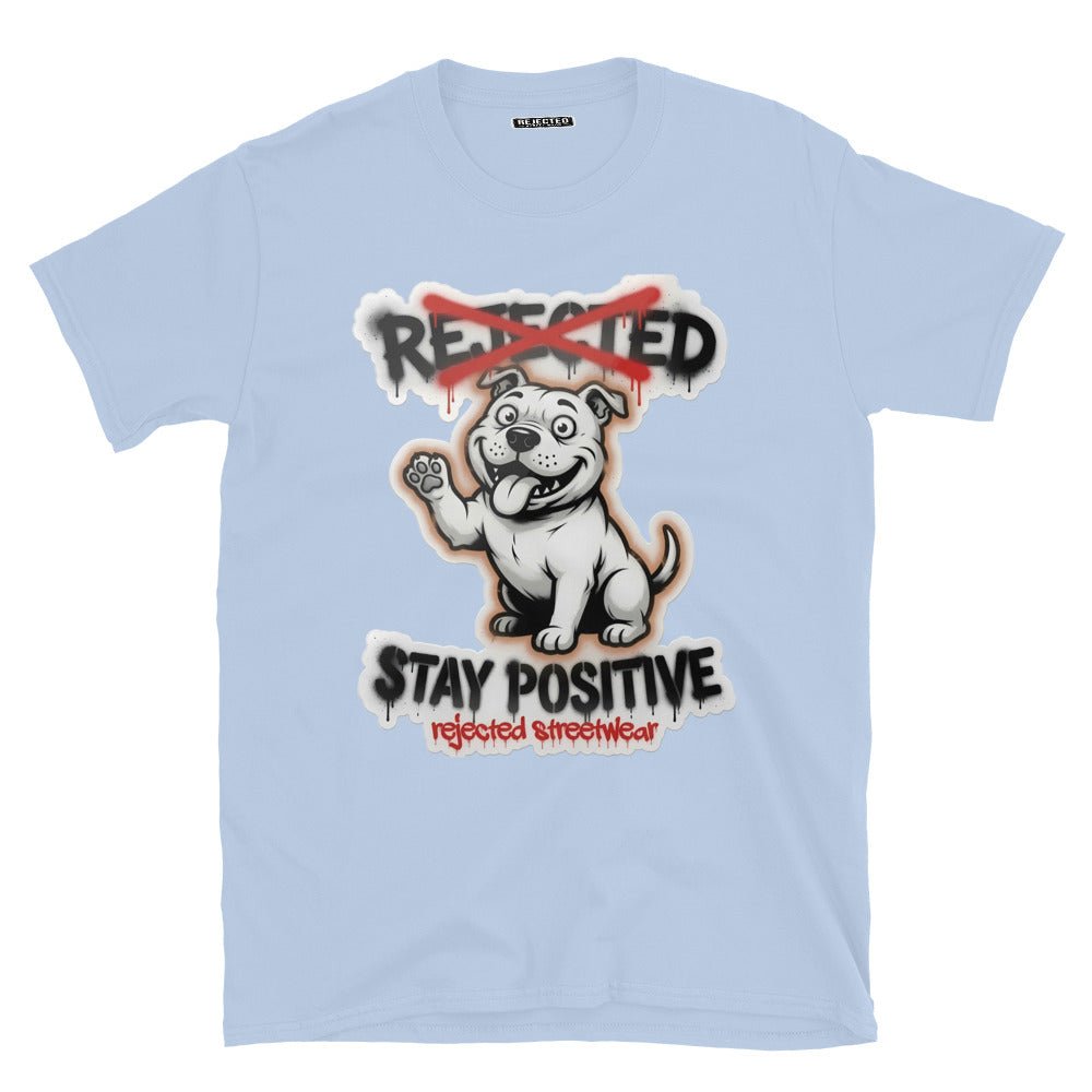 Stay Positive pit bull tee — white bully pup sitting with one paw raised, REJECTED crossed out in red