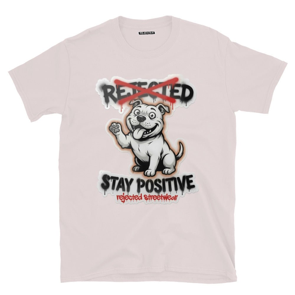 Stay Positive pit bull tee — white bully pup sitting with one paw raised, REJECTED crossed out in red