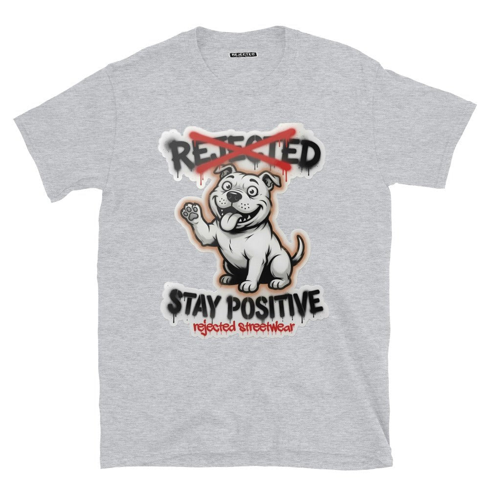 Stay Positive pit bull tee — white bully pup sitting with one paw raised, REJECTED crossed out in red