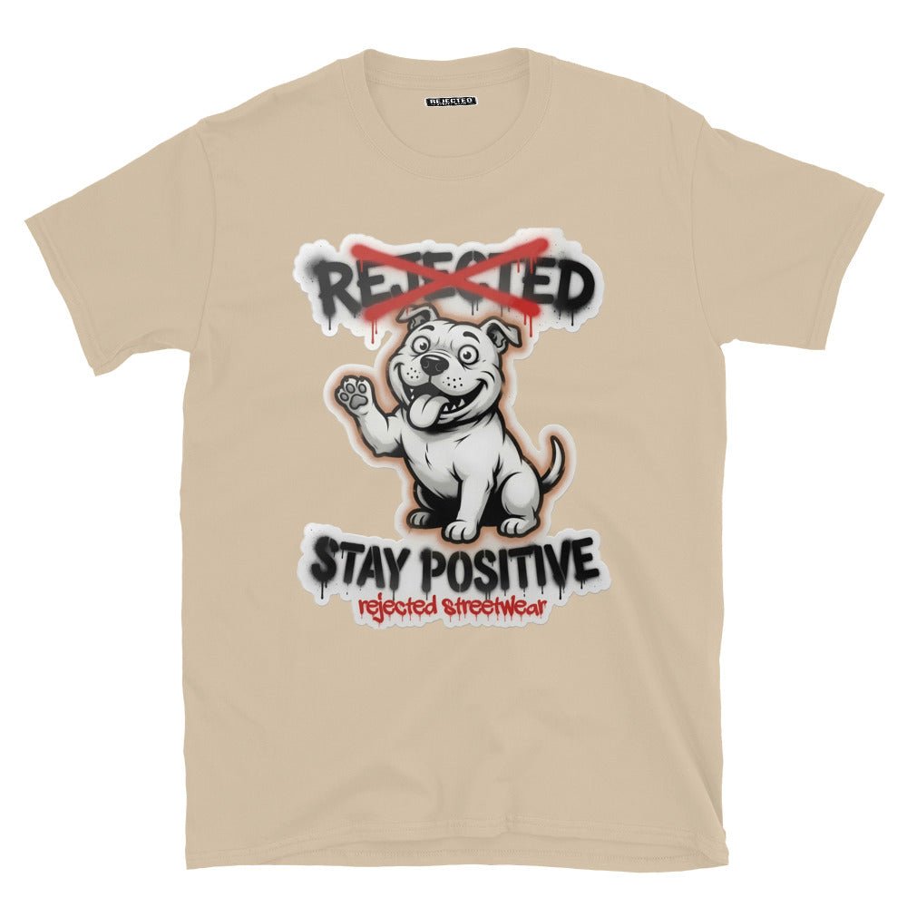 Stay Positive pit bull tee — white bully pup sitting with one paw raised, REJECTED crossed out in red
